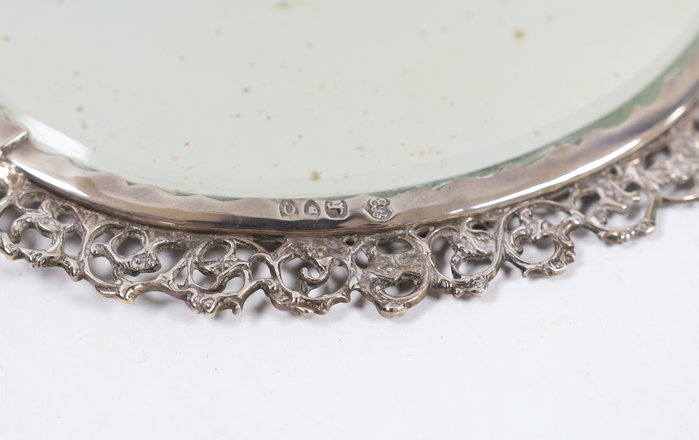 An ornate late Victorian silver mounted hand mirror, Edward Brown, London, 1891, 30.1cm.